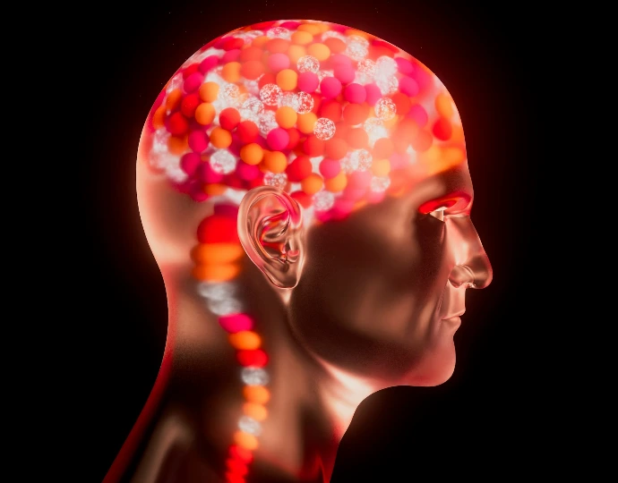 A metallic human head profile with glowing red and orange spheres inside the brain